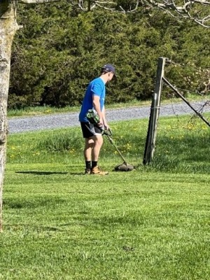 United way team member weed whacking